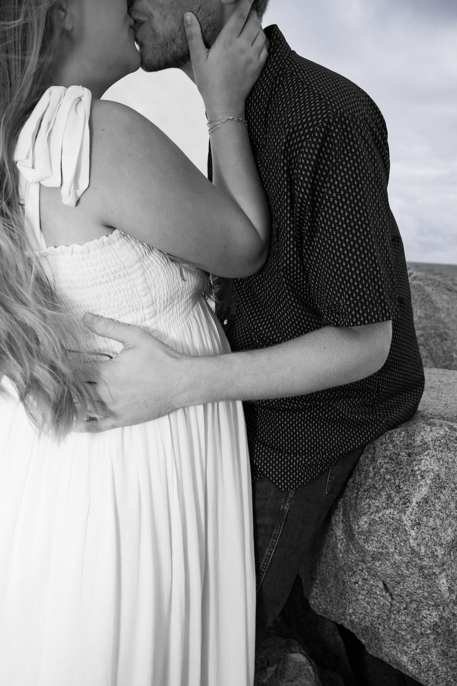 Intimate black and white portrait of couple in close embrace.