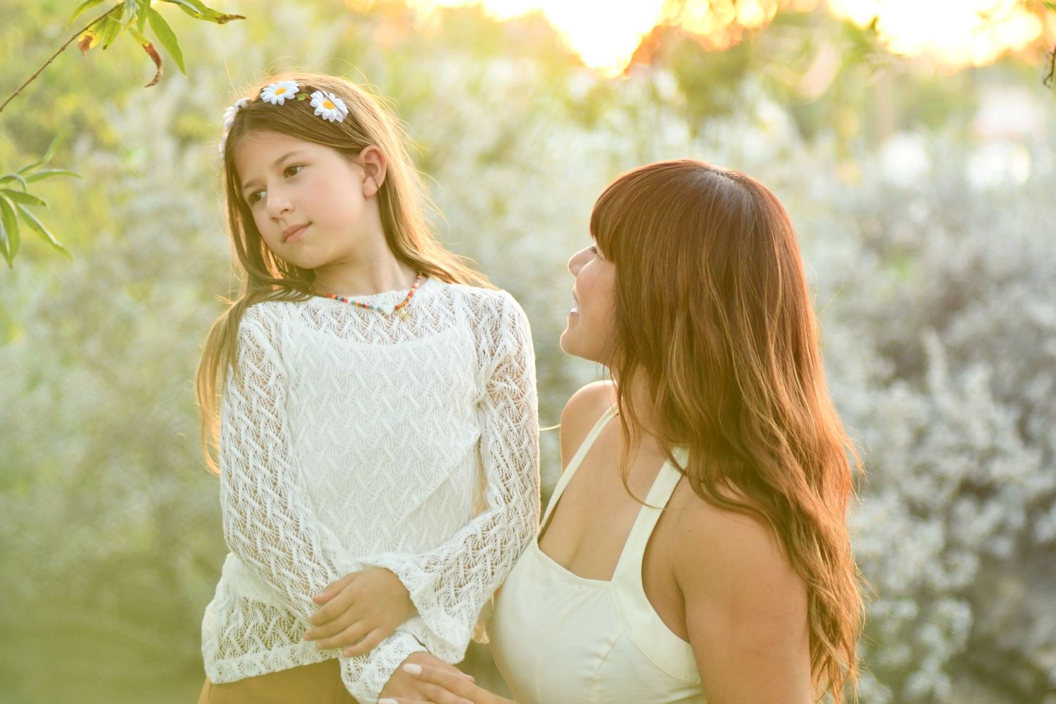An ethereal outdoor portrait session with white lace details and golden sunset lighting.
