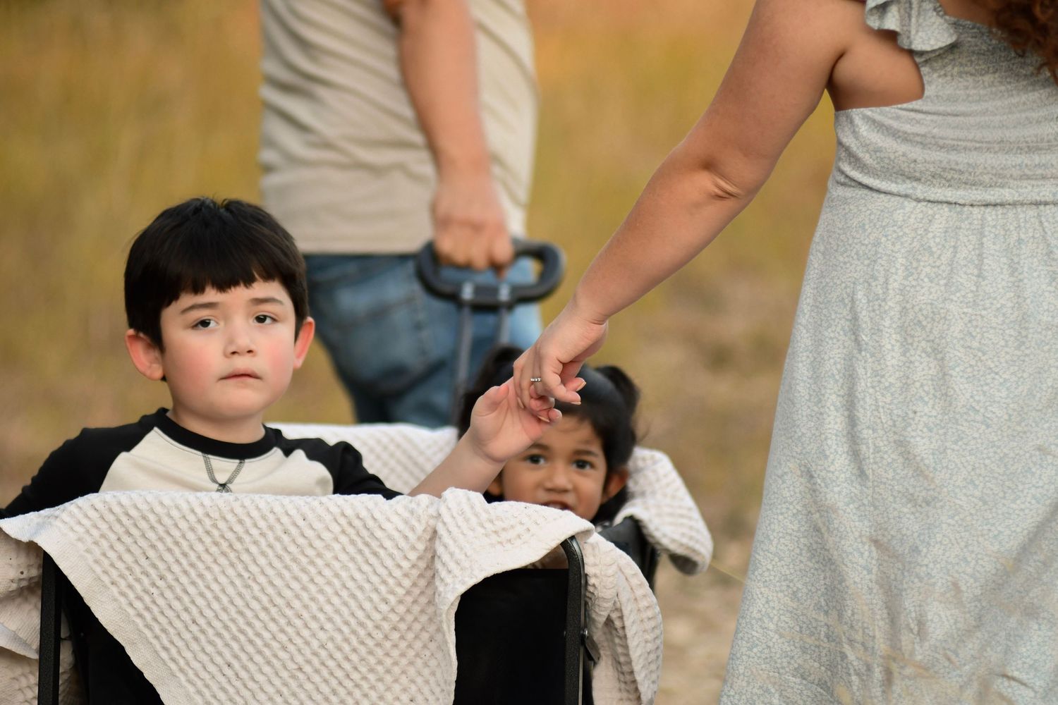 Sweet candid moments captured during a family photoshoot in casual attire.
