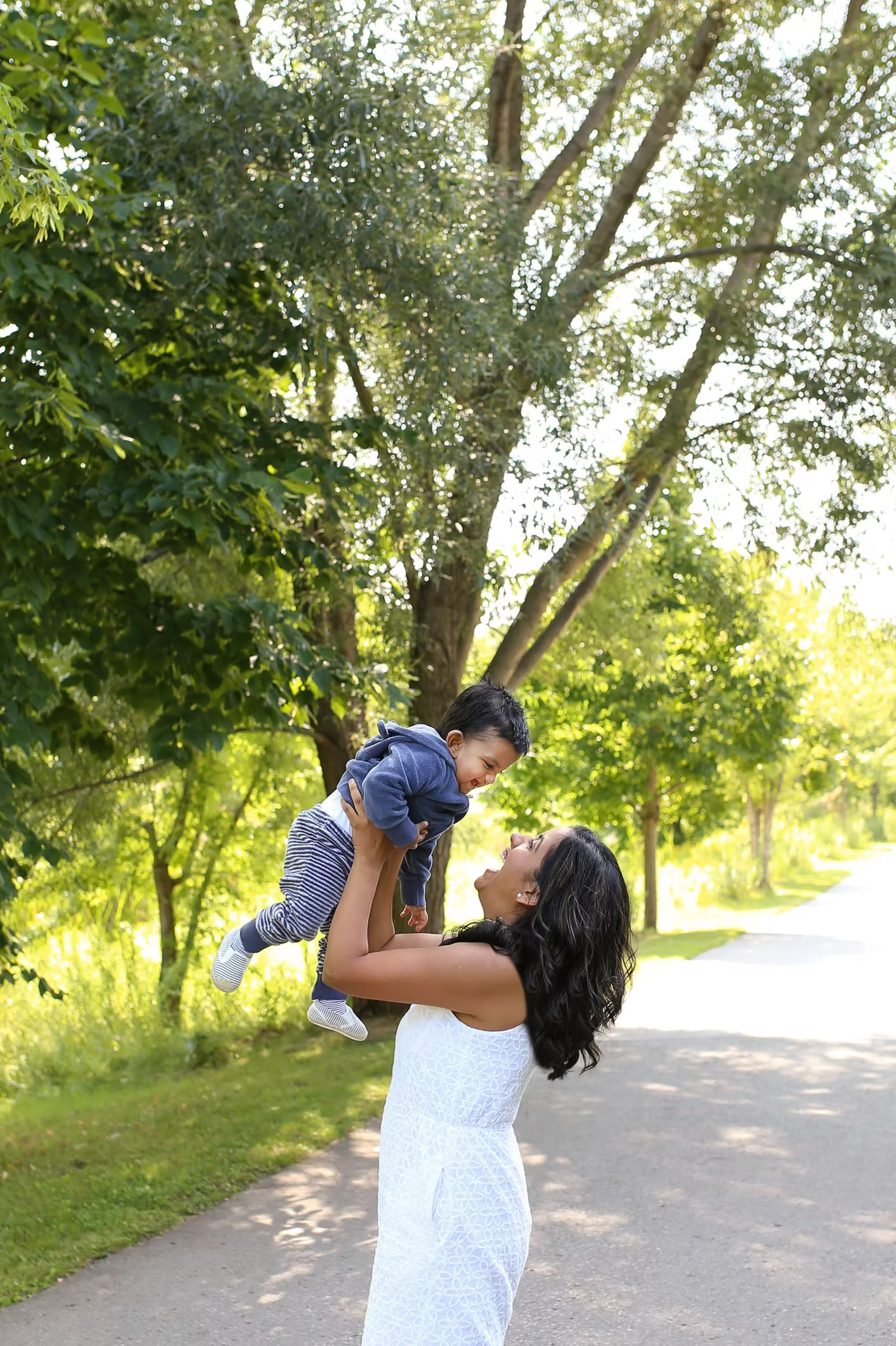 Joyful outdoor moments captured in a sunlit park pathway.