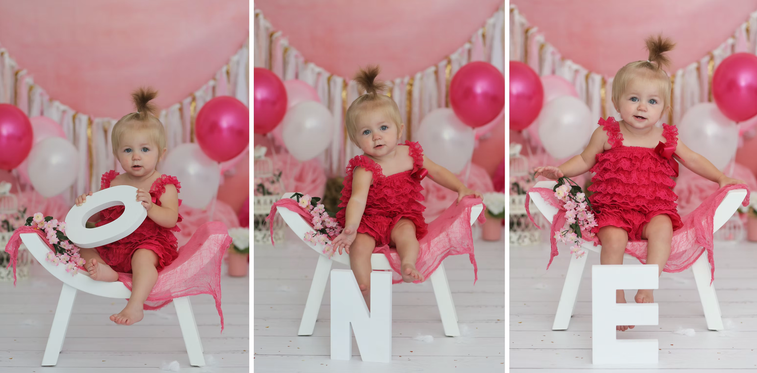 Pink birthday setup with balloons and white letter banners for celebration photos.