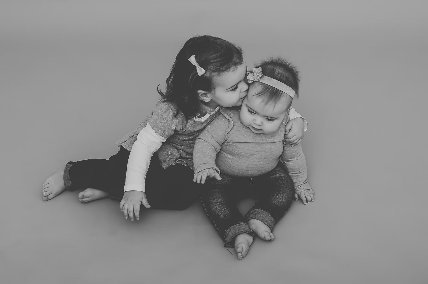 Black and white portrait series showing tender family moments.