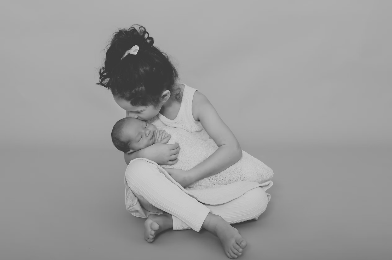 Black and white portrait series showing tender family interactions.