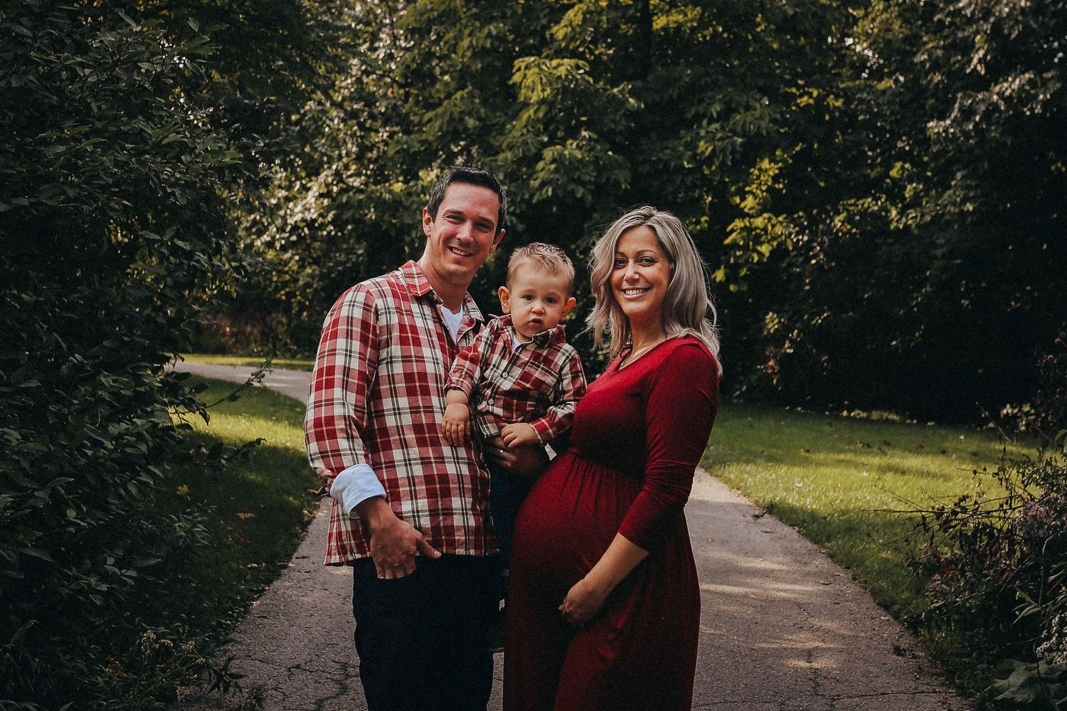 Romantic couple photos captured on a winding woodland path during golden hour.
