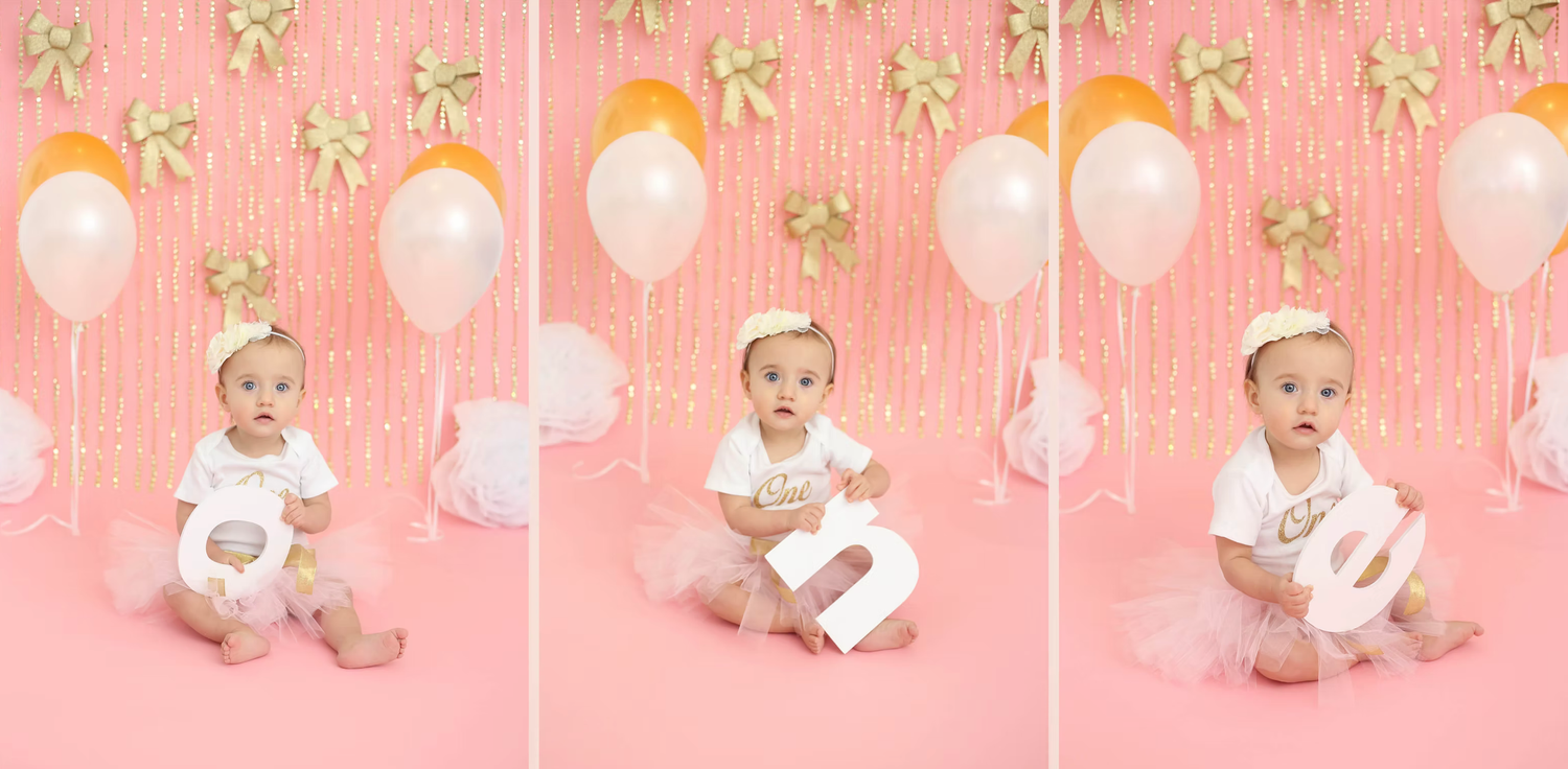 Pink and gold party setup with white balloons and decorative bows for a birthday celebration.