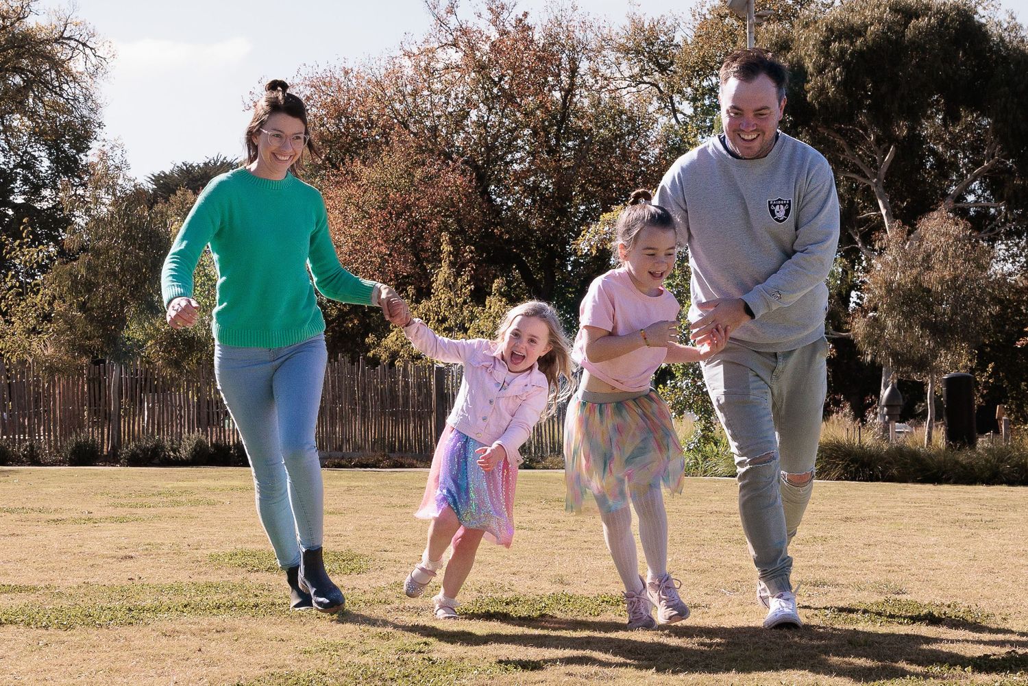 Mum, Dad and 2 girls playing in the park at Lifestyle Family session