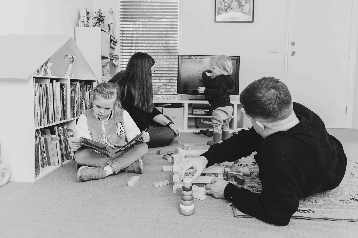 Mum, Dad and their 2 children playing in the lounge room.  Leigh Ball documentary family photographer