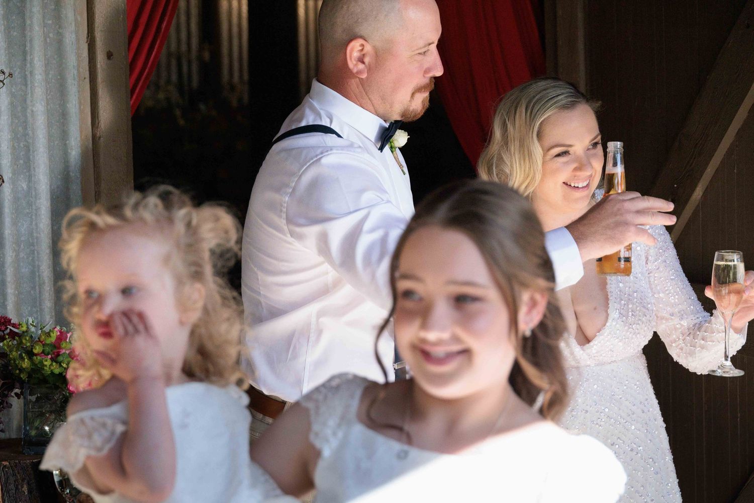 Bride and groom during reception with their children in foreground at Quirindi Stables, Vic