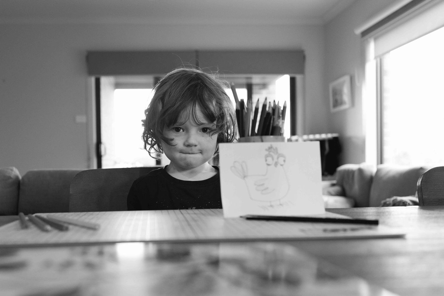 Young boy next to a tin of pencils