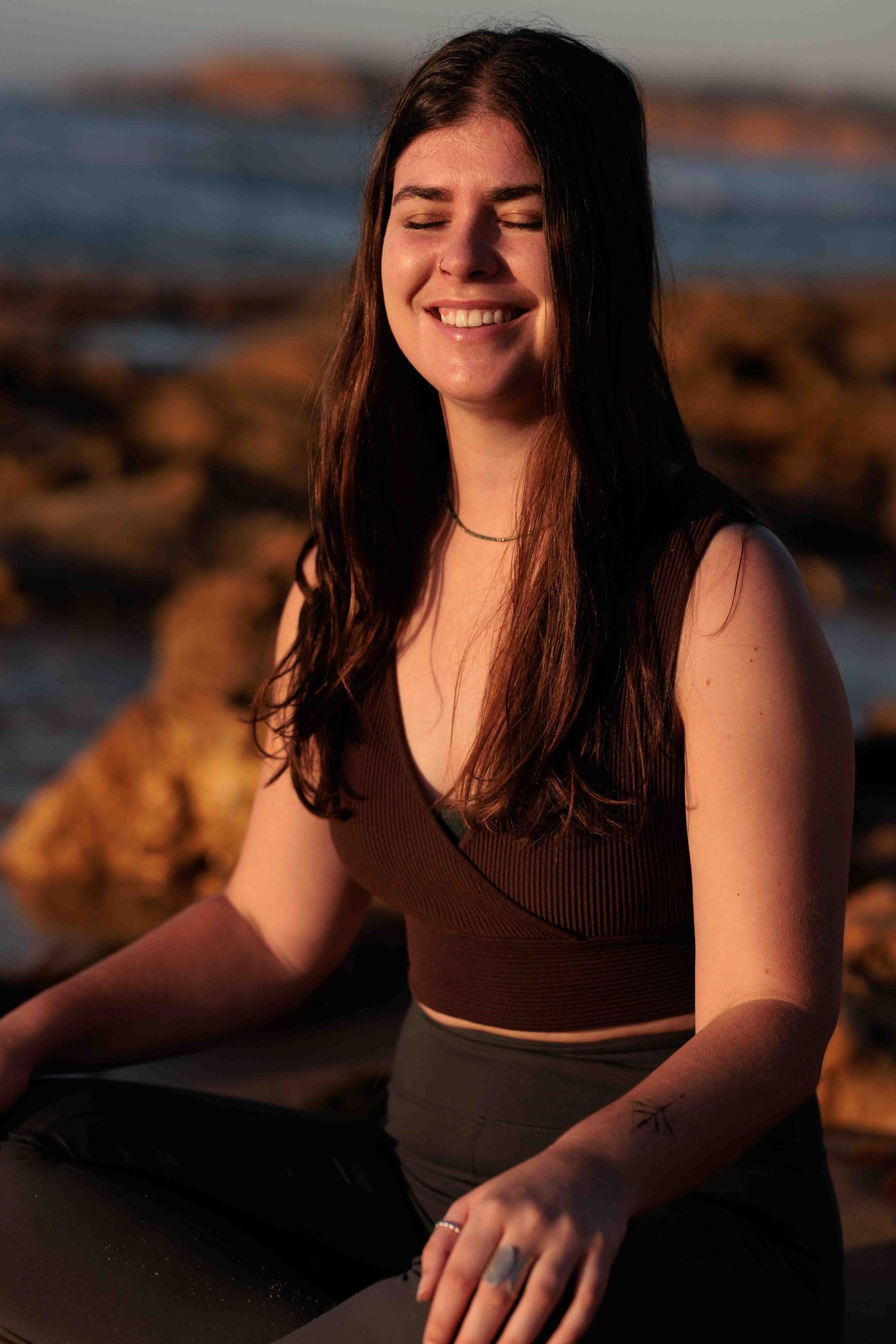 Woman meditating on the beach