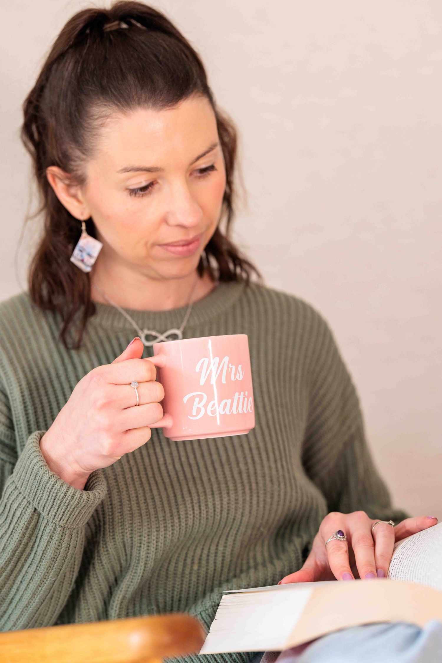 Relaxed casual phot of woman reading and drinking tea