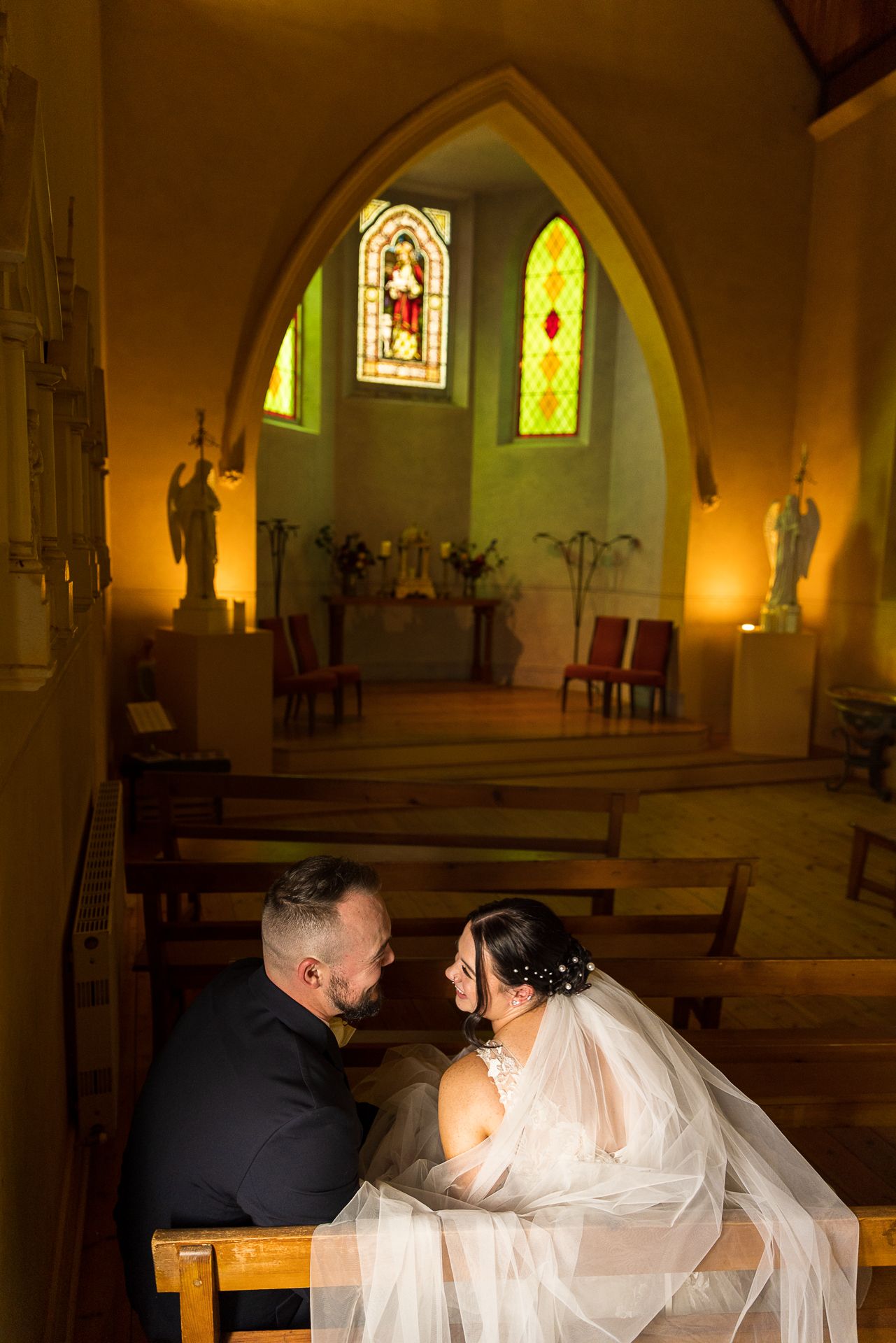 Bride and Groom share a moment to talk and laugh following their wedding ceremony at Daylesford Convent, Daylesford Victoria.