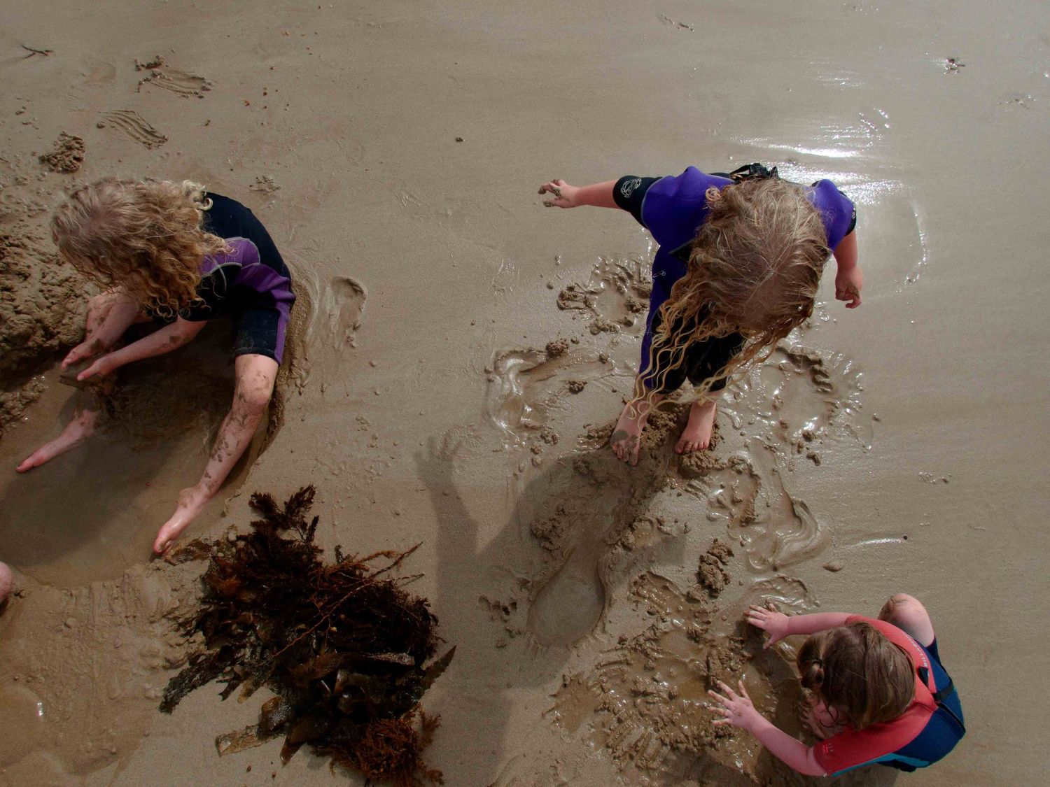3 kids enjoying some Beach fun taken from above. Leigh Ball documentary family photographer