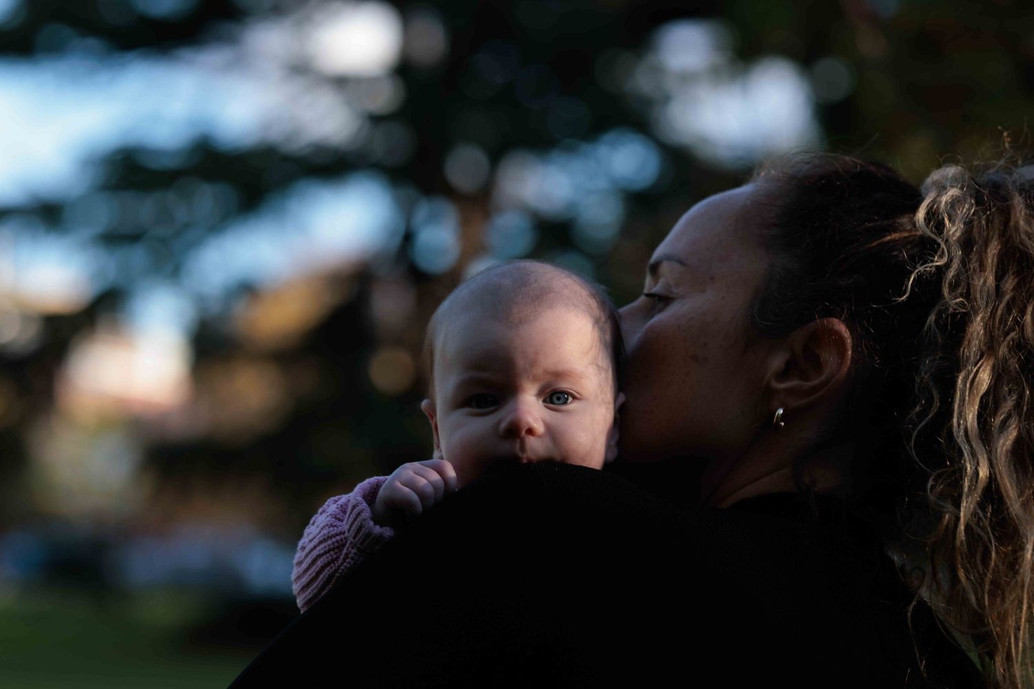 Candid photo of mum and with young baby. Queens Park, Moonee Ponds, Vic by Leigh Ball, documentary photographer.
