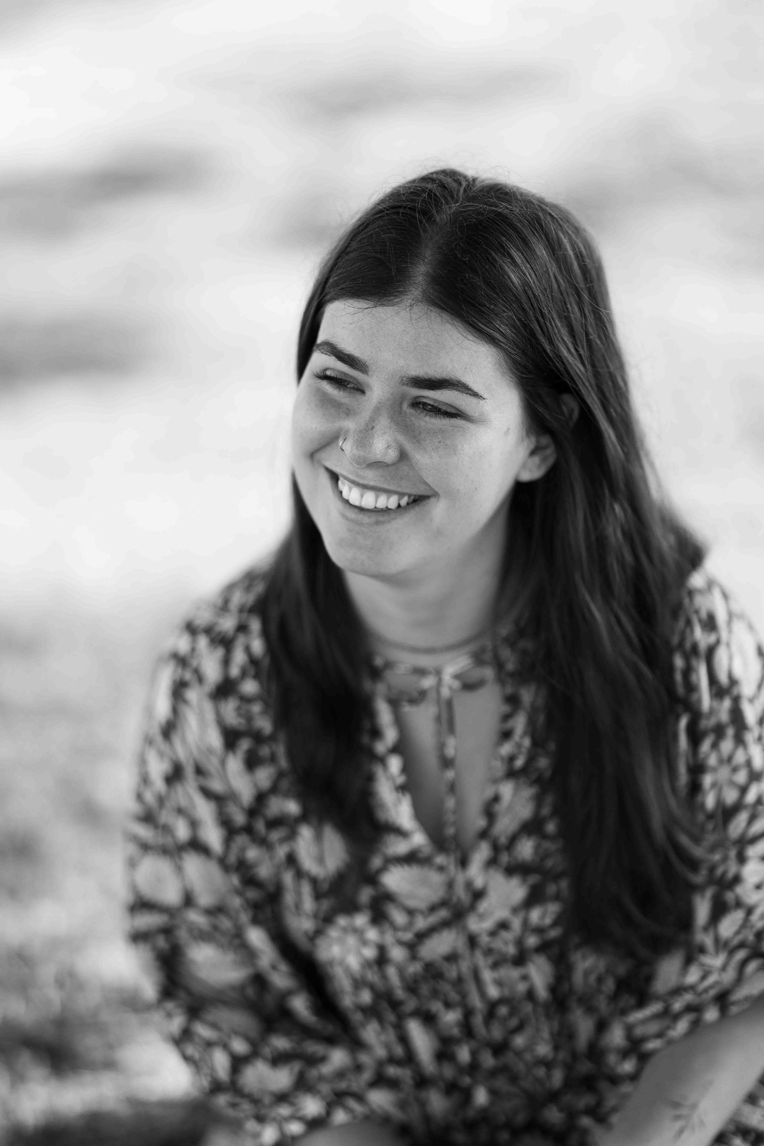 black and white candid photo of woman smiling