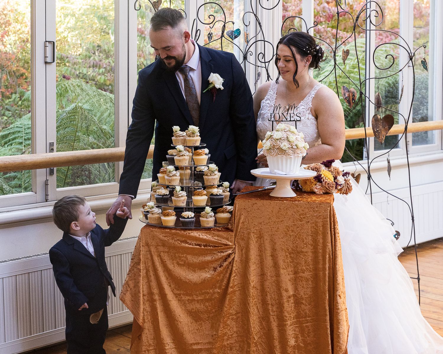 young child sneaking some icing off wedding cakes