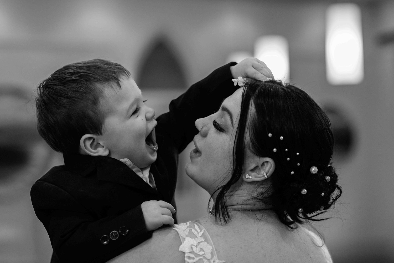 young boy playing with his newly married mum