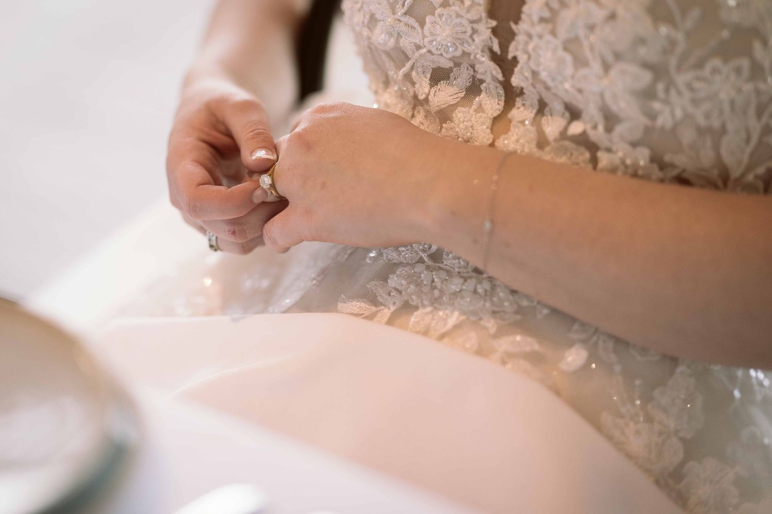 woman in wedding dress looking at her new wedding ring