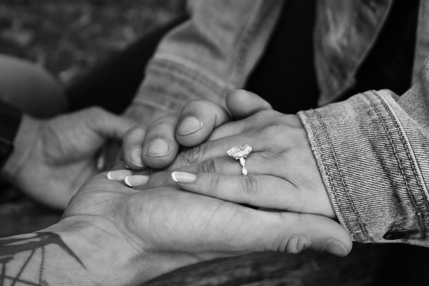 He holds her hand and they admire the ring and symbolism after his proposal of marriage.