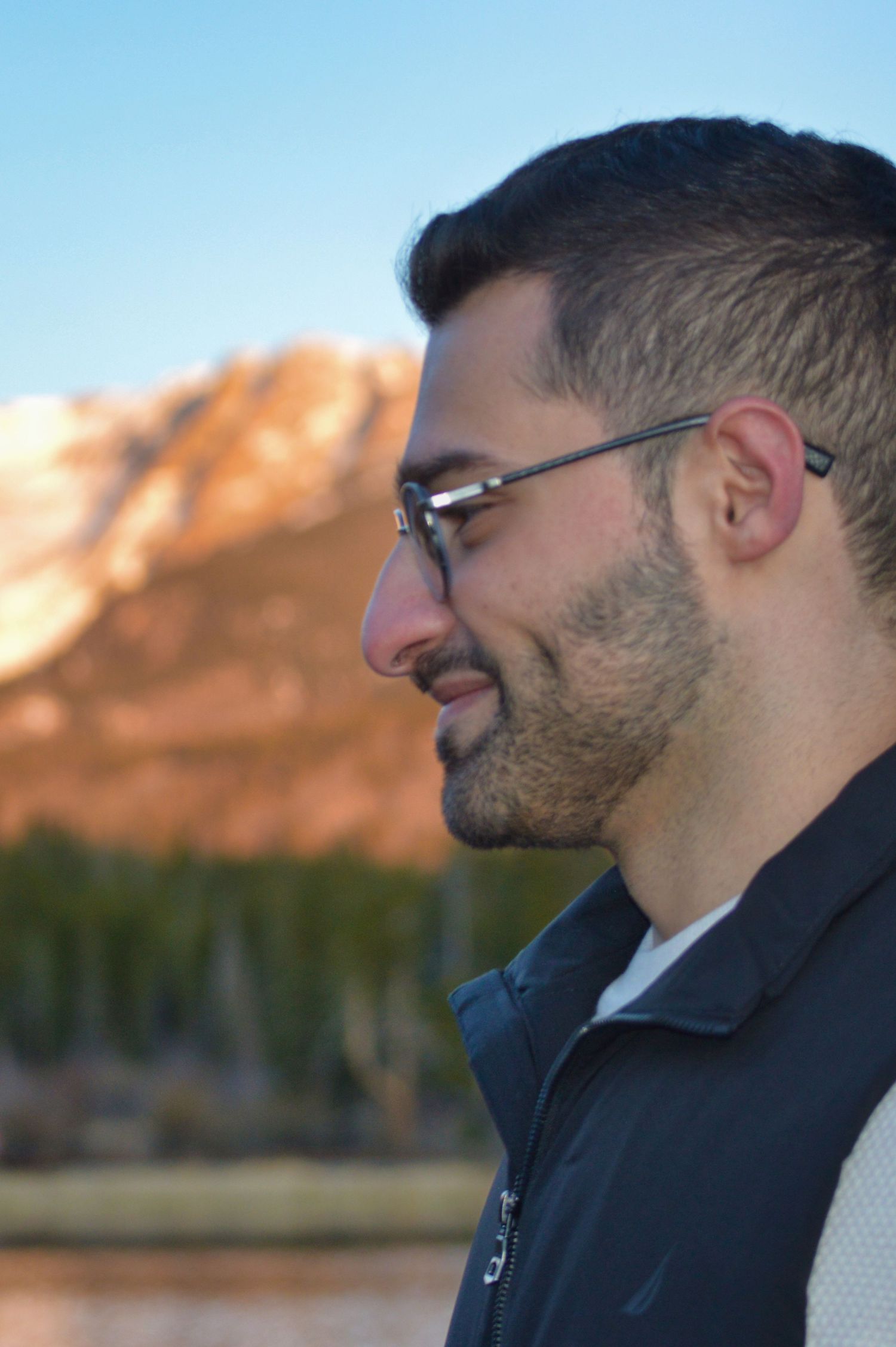 Only the man, but he is staring at his now fiancé after he proposed at Sprague Lake. Pixcapades | The Rocky Mountain Proposal Photographer