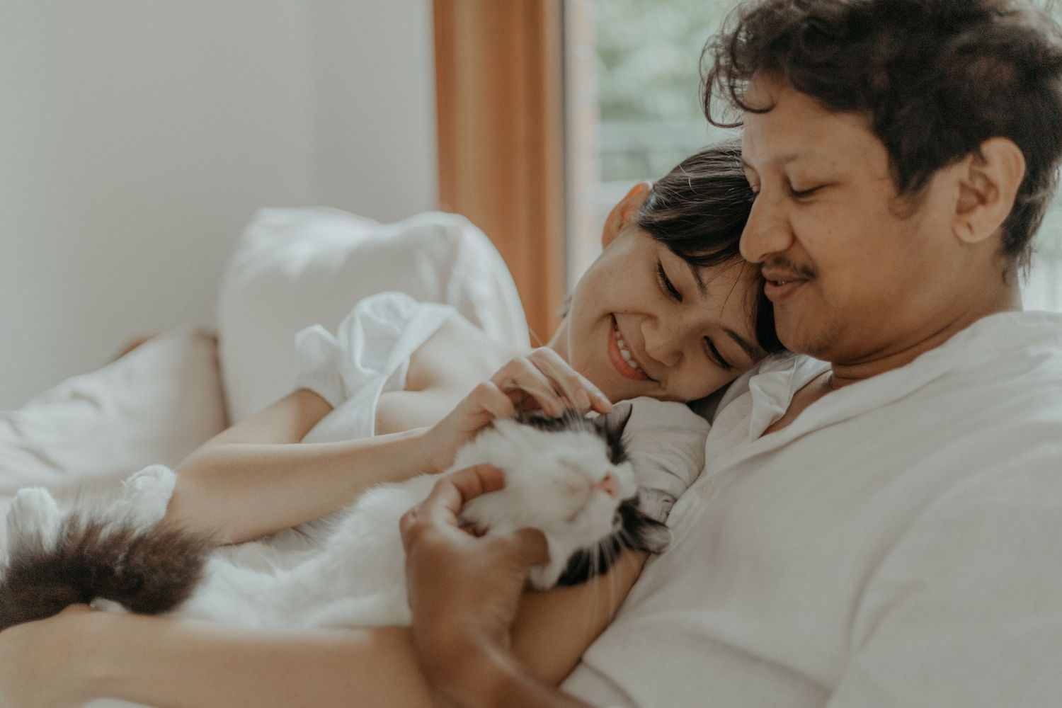 Malay soon-to-be parents cuddling with cat during a maternity shoot in Kuala Lumpur