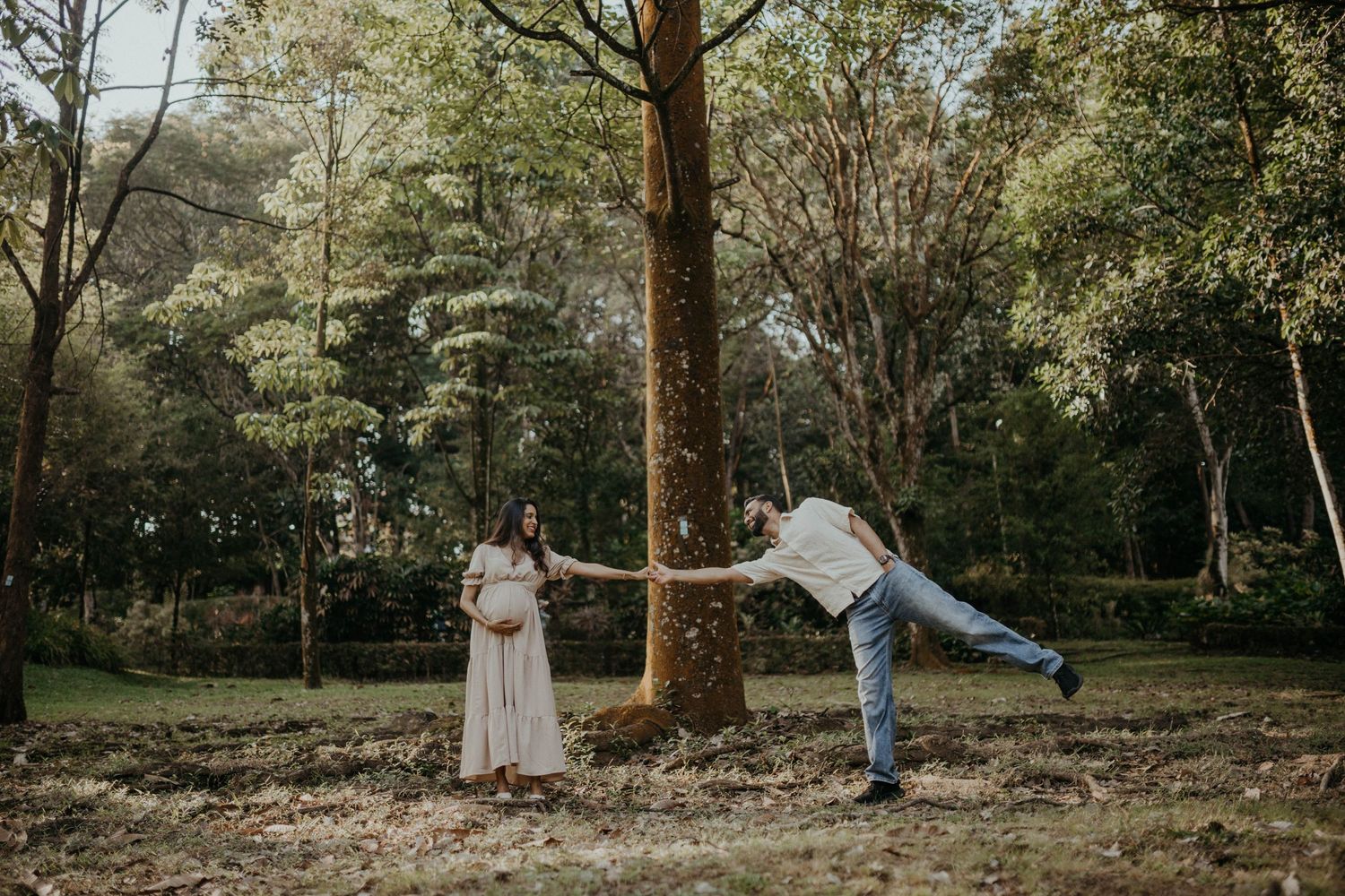 Indian soon-to-be parents holding hands and playing at a maternity photoshoot in Kuala Lumpur, Selangor