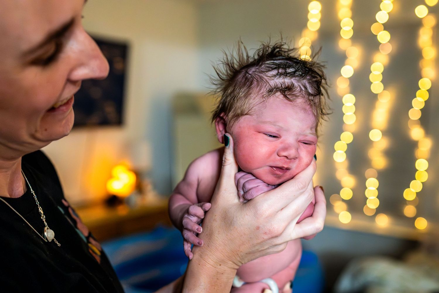 Birth photography sequence with warm lighting showing first moments after delivery.