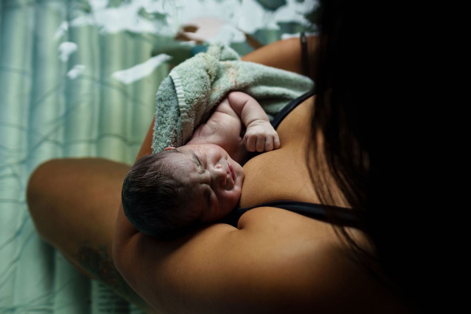 Close-up of sleeping newborn during first moments after birth.