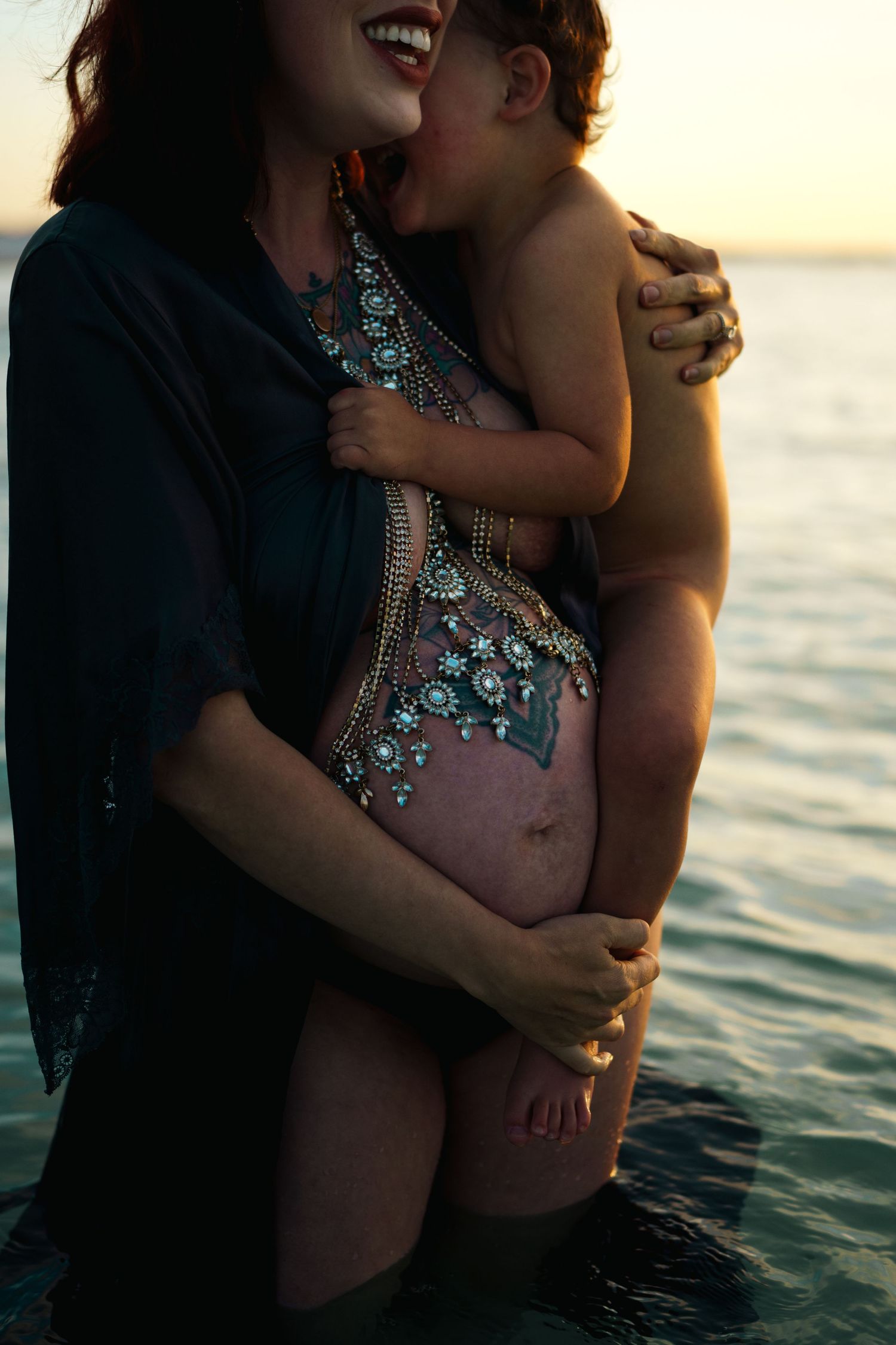 Five intimate sunset photos in water showing couple embracing in silhouette with warm golden light and ocean backdrop.