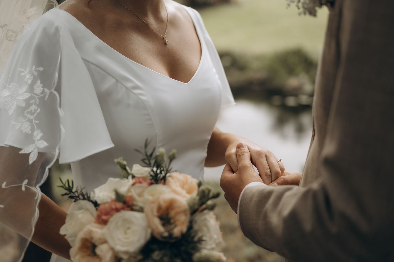 detail of bride and groom holding hands during documenting naturally-looking wedding photos in Stockholm