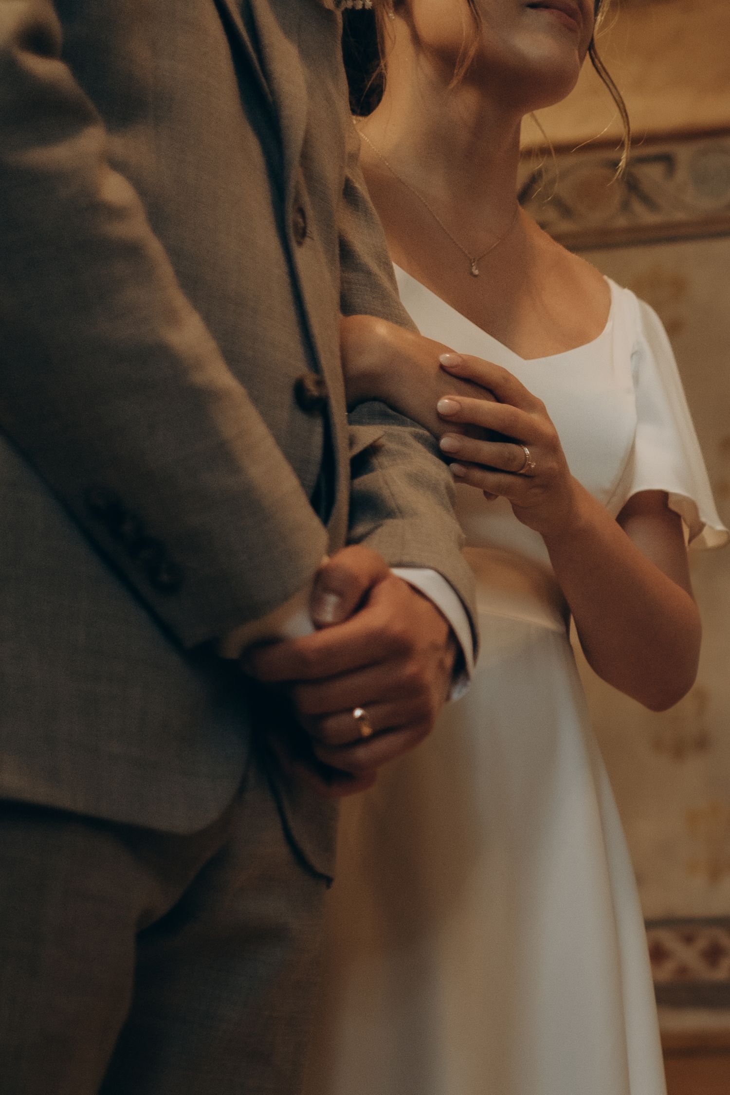 bride and groom's hands with wedding rings during wedding ceremony in Stockholm being captured by documentary wedding photographer