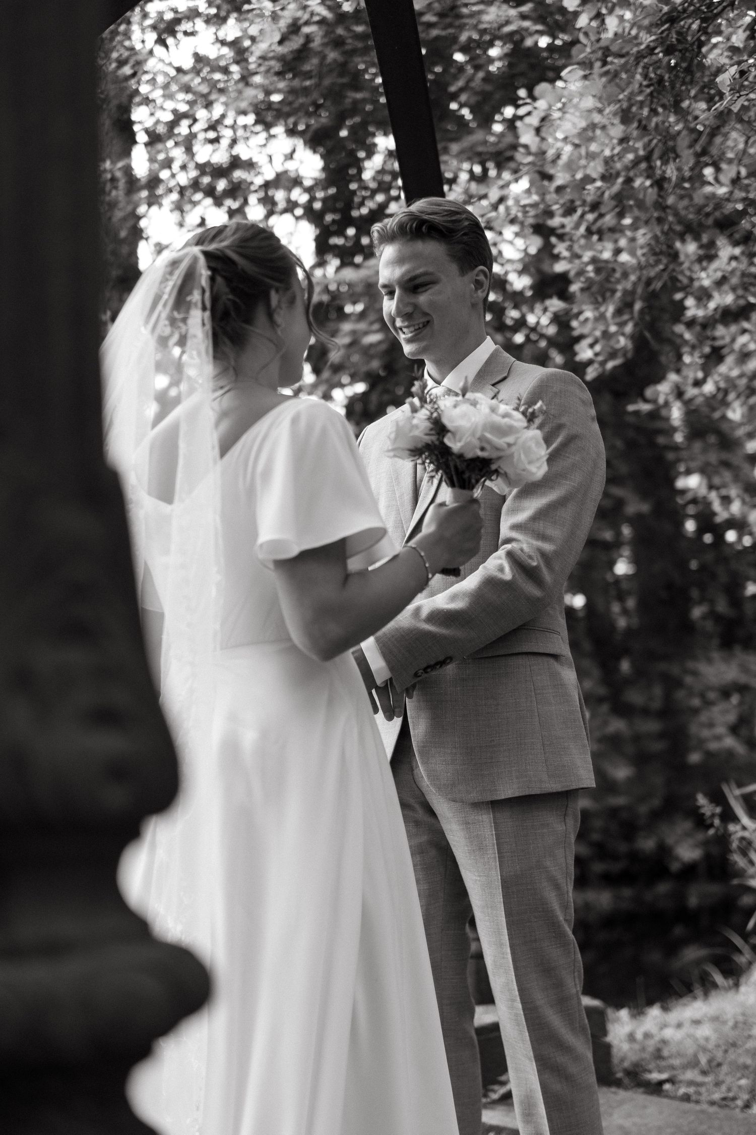 bride and groom share first look moment while being captured by cinematic wedding photographer in Stockholm