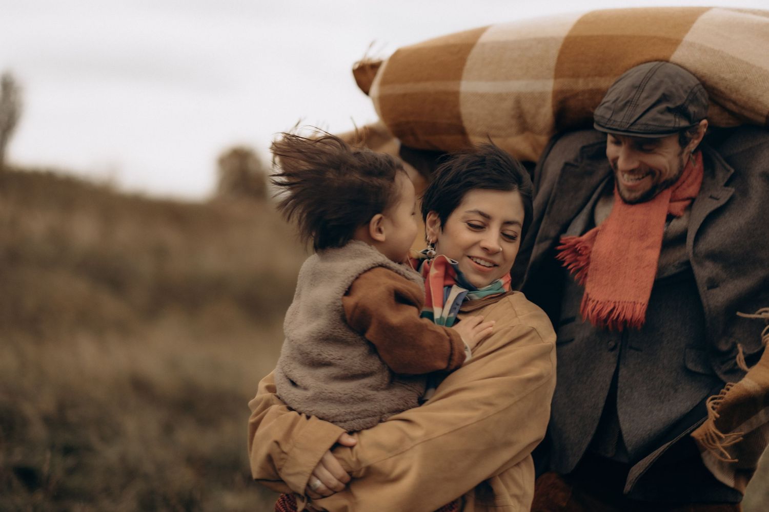 family running through fields in Autumn while being captured by family photographer in Stockholm with documentary style