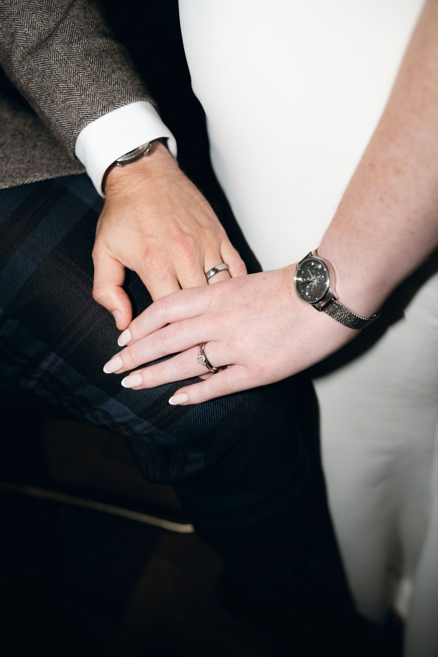 Close-up photo series showing hands with engagement rings against a dark background.