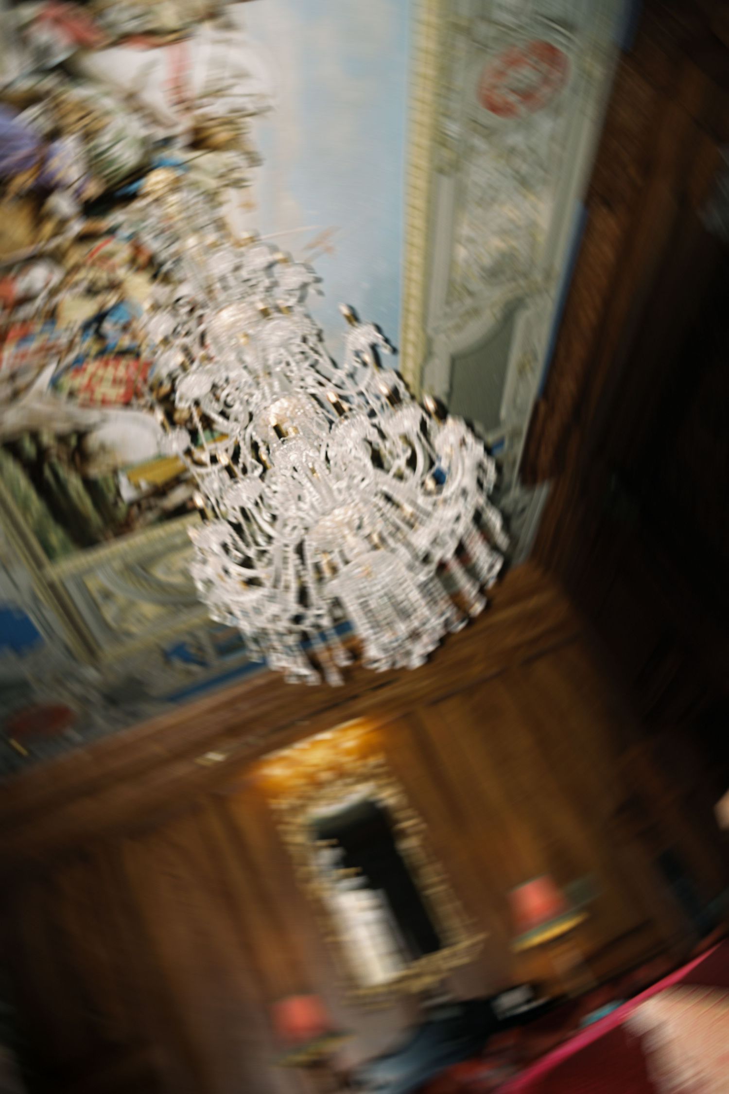 Abstract motion blur photograph of a chandelier creating a swirling pattern of light and movement.