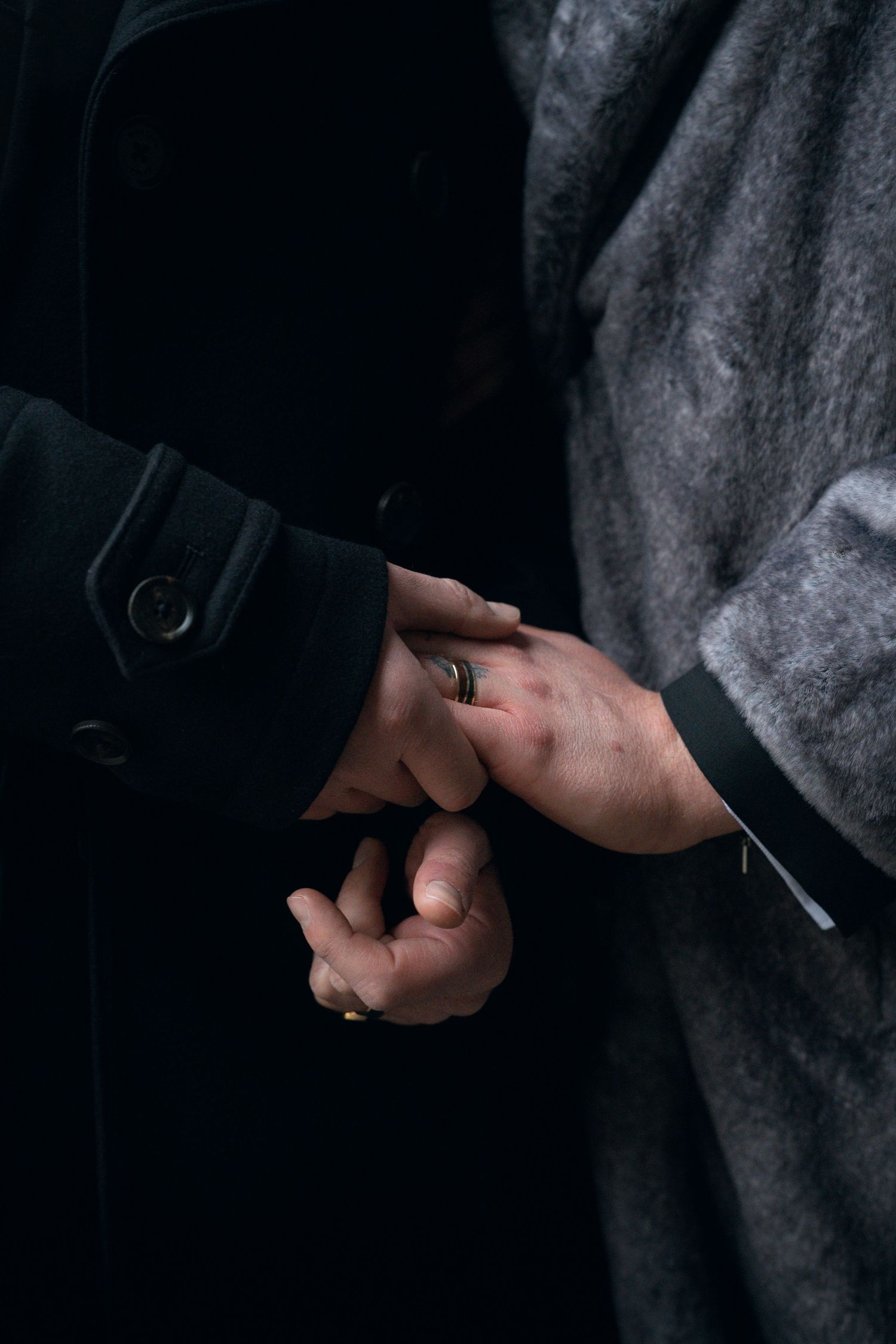 Close-up sequence showing hands exchanging a small object in dim lighting.