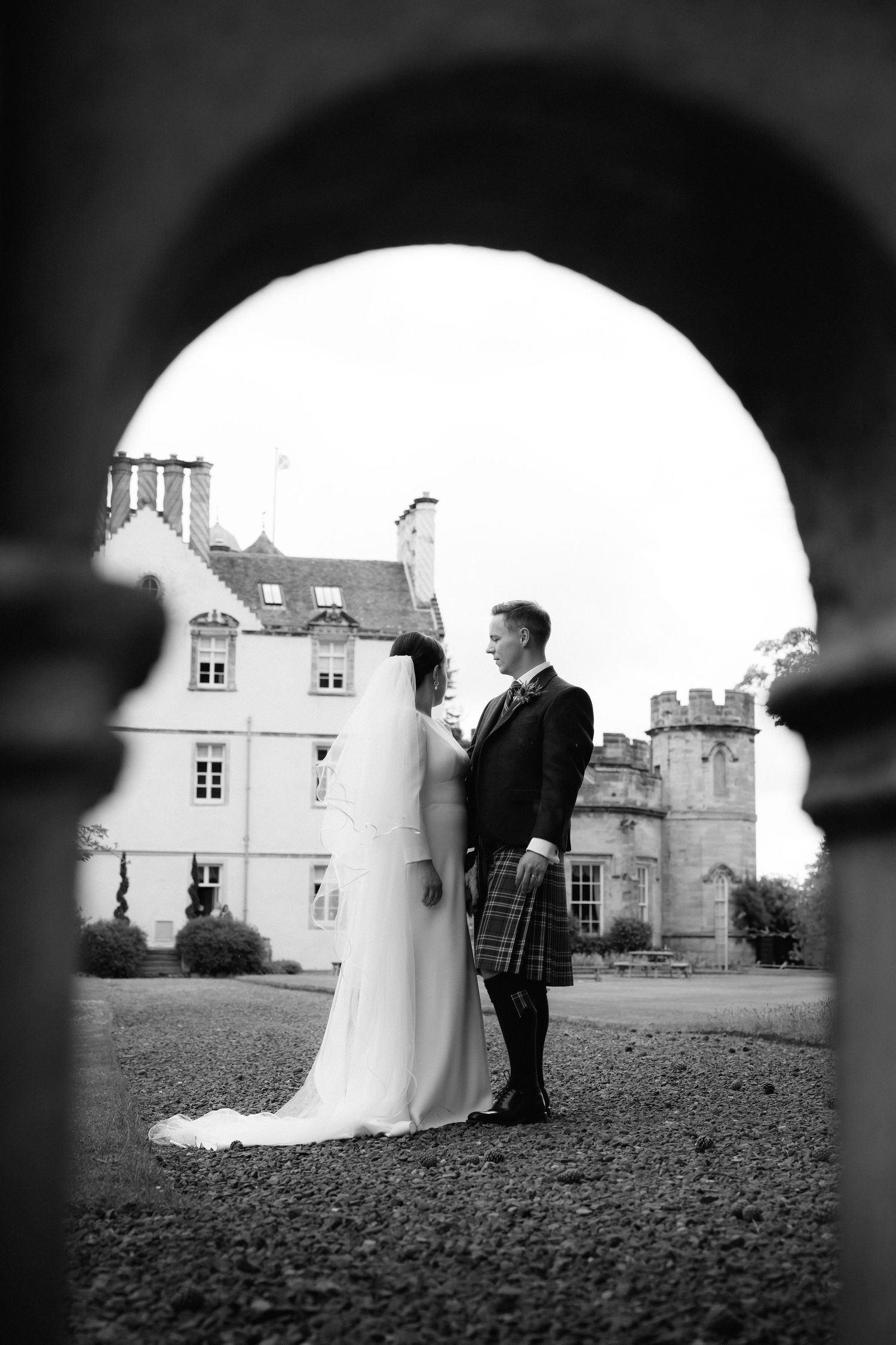 A romantic black and white wedding photo sequence showing a couple in front of a grand Scottish castle.