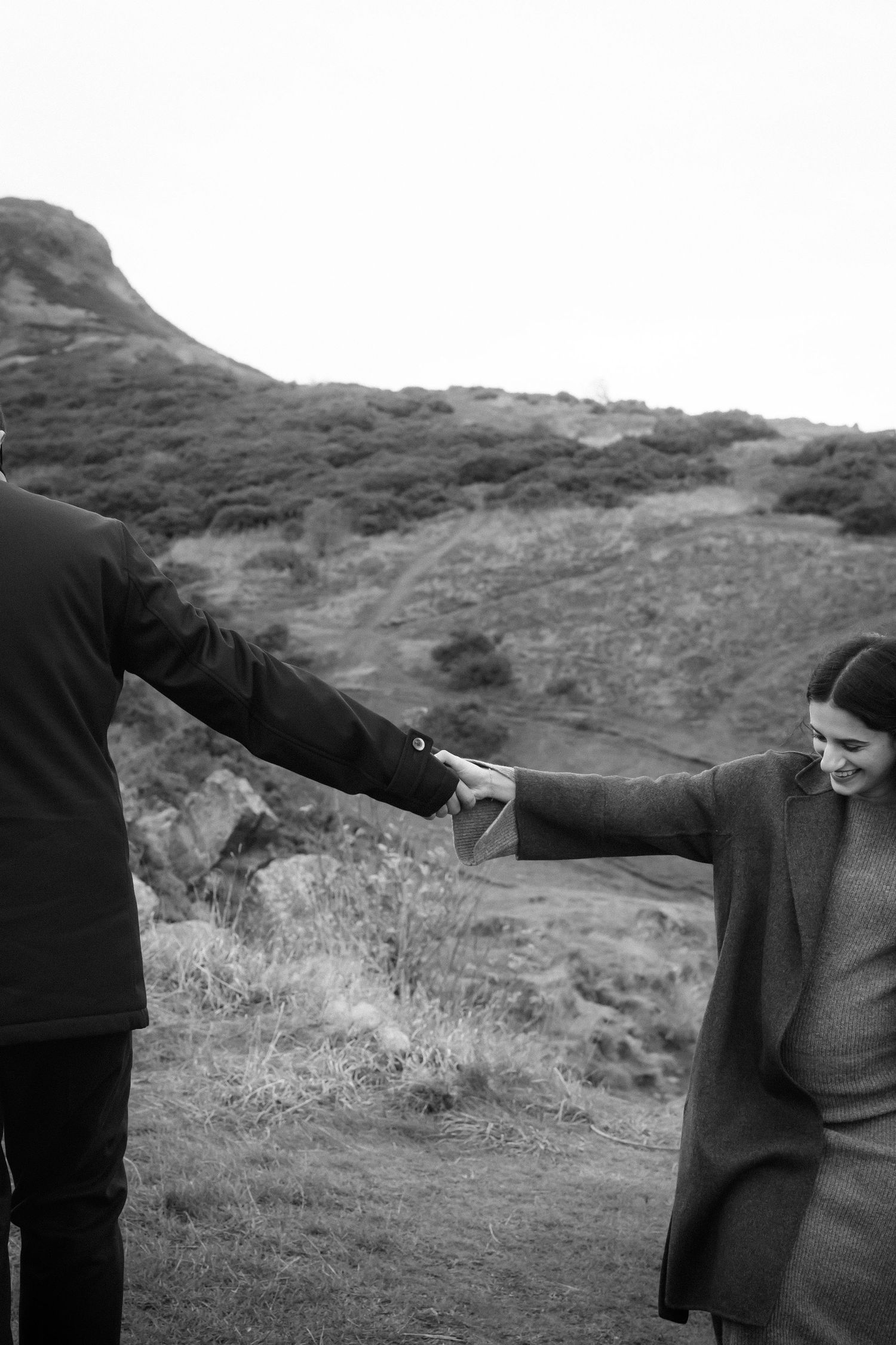 A sequence of black and white photos showing two people in a confrontational stance on a hillside.