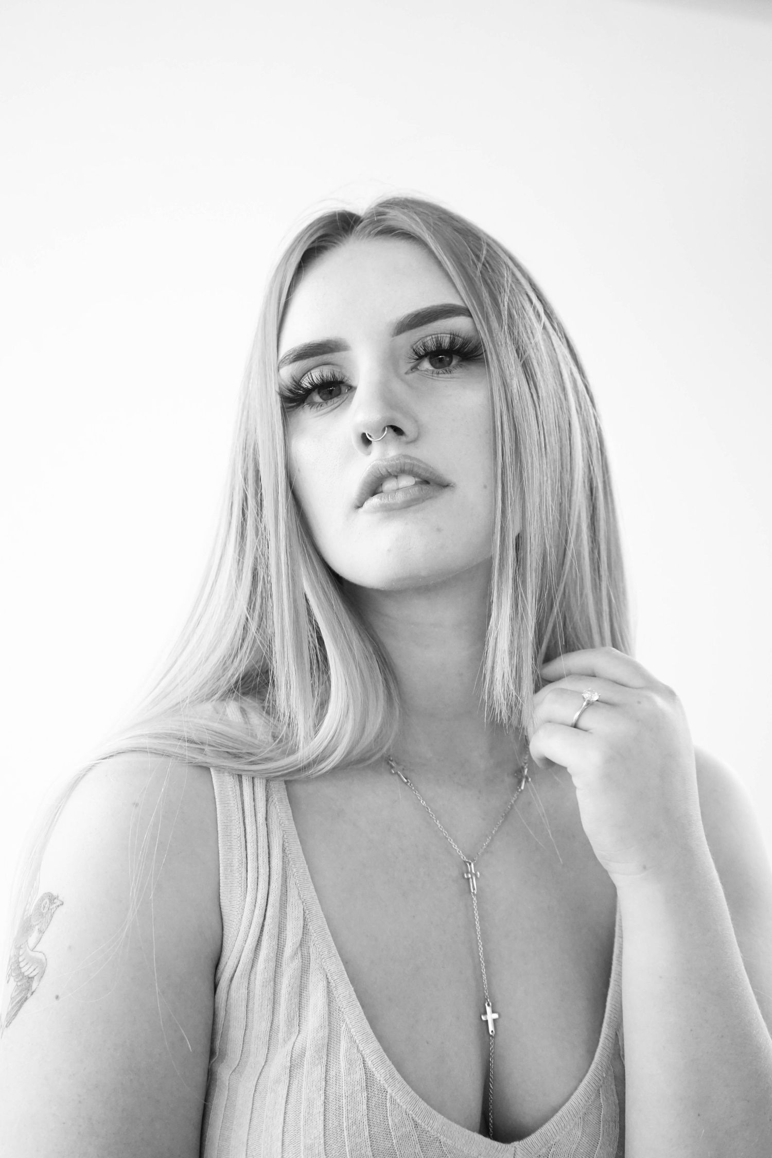 Black and white image of blonde girl on white backdrop