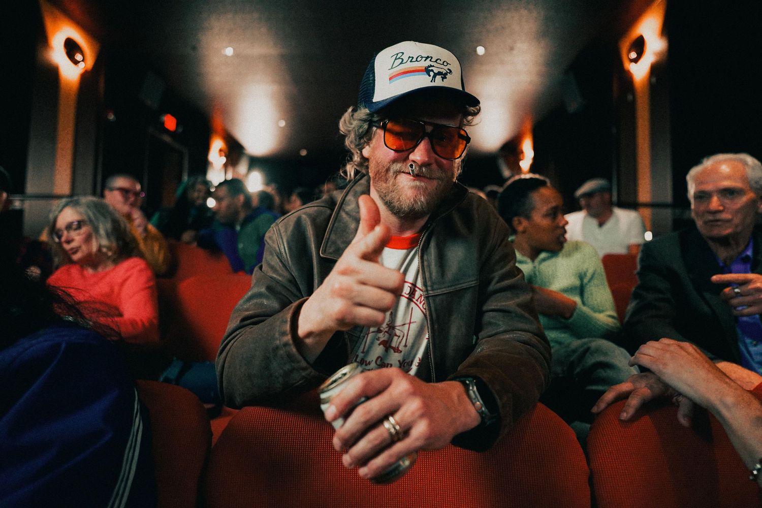 Portrait of Allen Stone looking at the camera in a crowded movie theater during behind the scenes moments of a music video