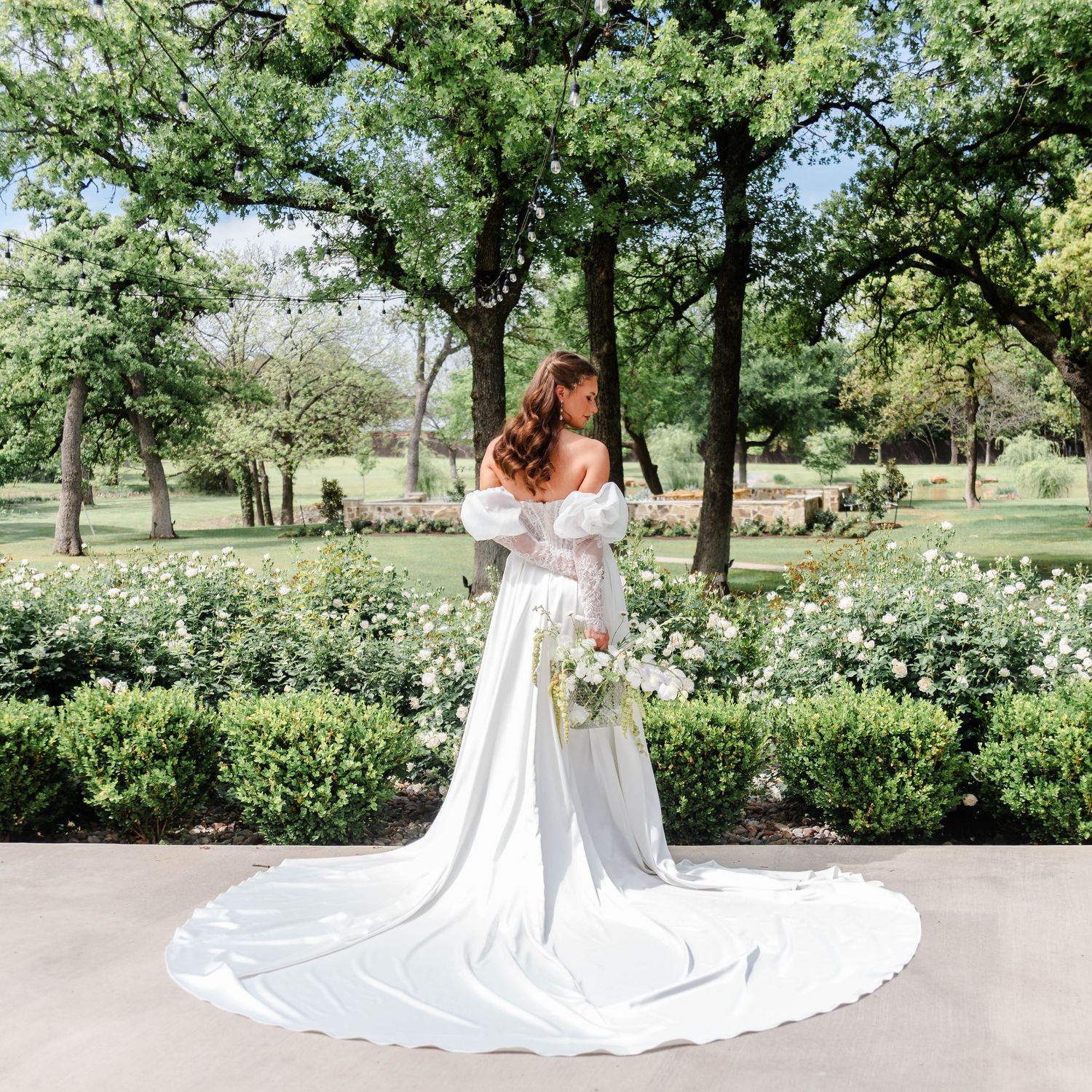 a woman holds her bouquet in her bridal gown