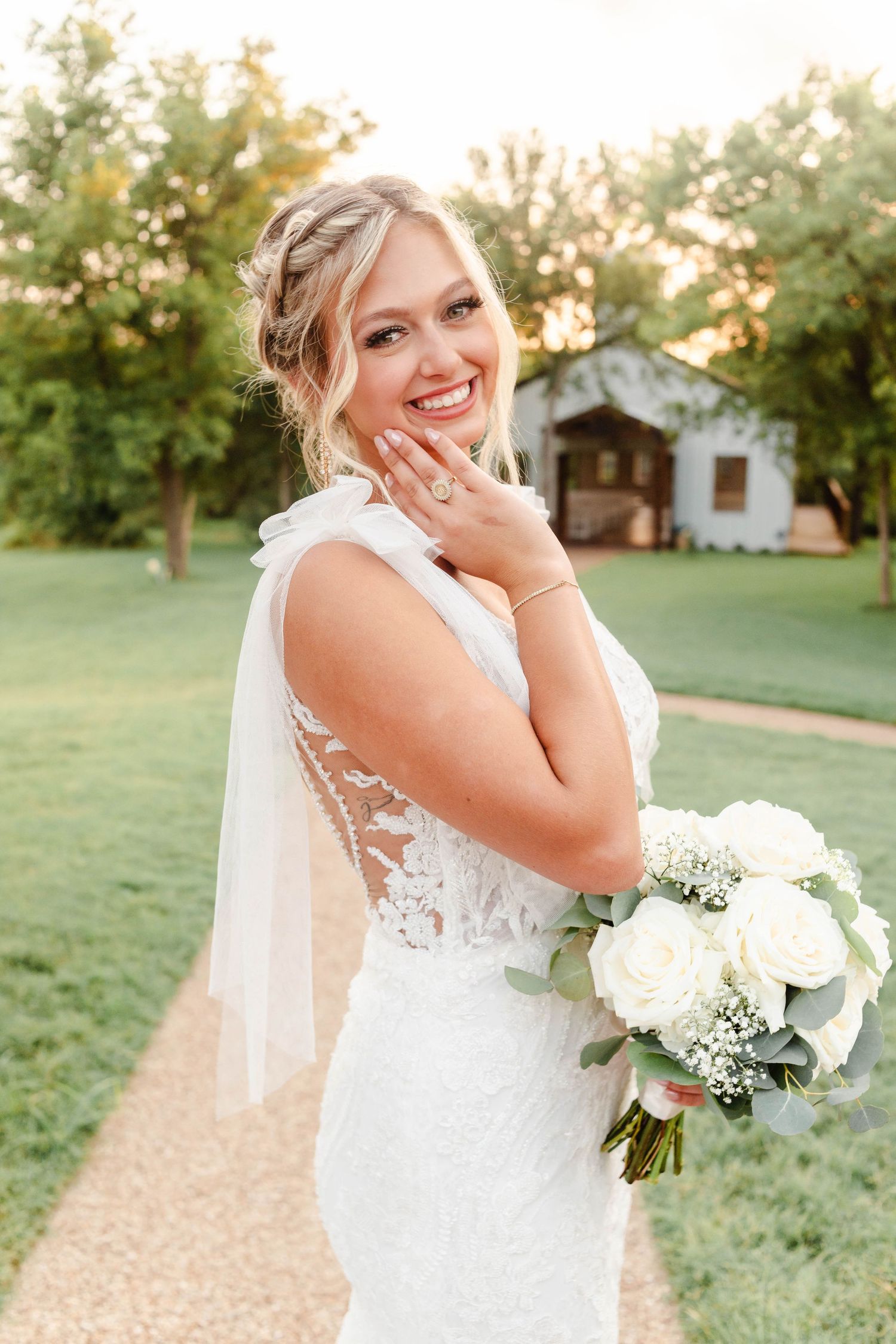 a bride smiling and holding her face