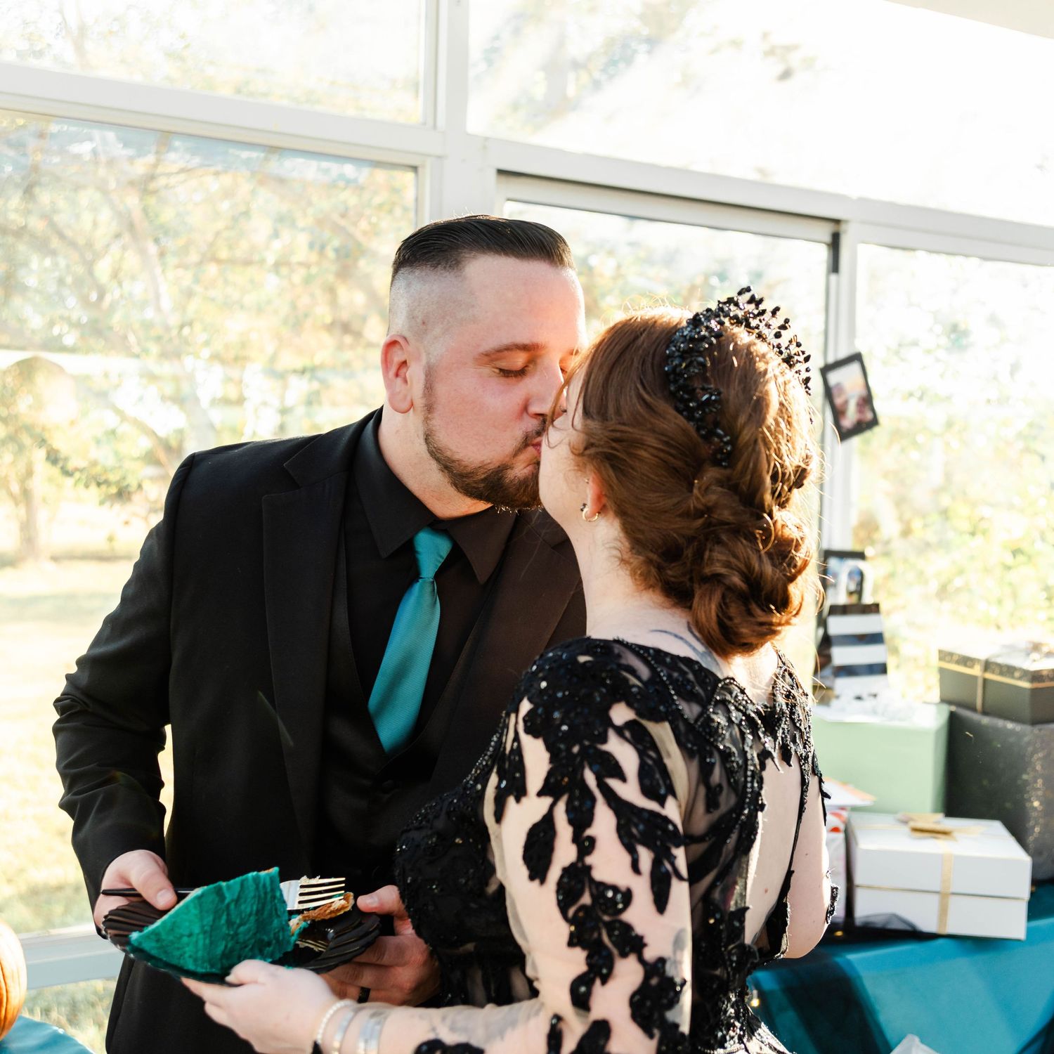 Couple kissing after cutting cake