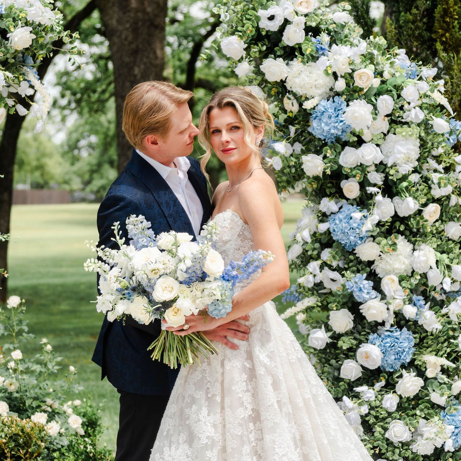 couple at the ceremony site in the florals