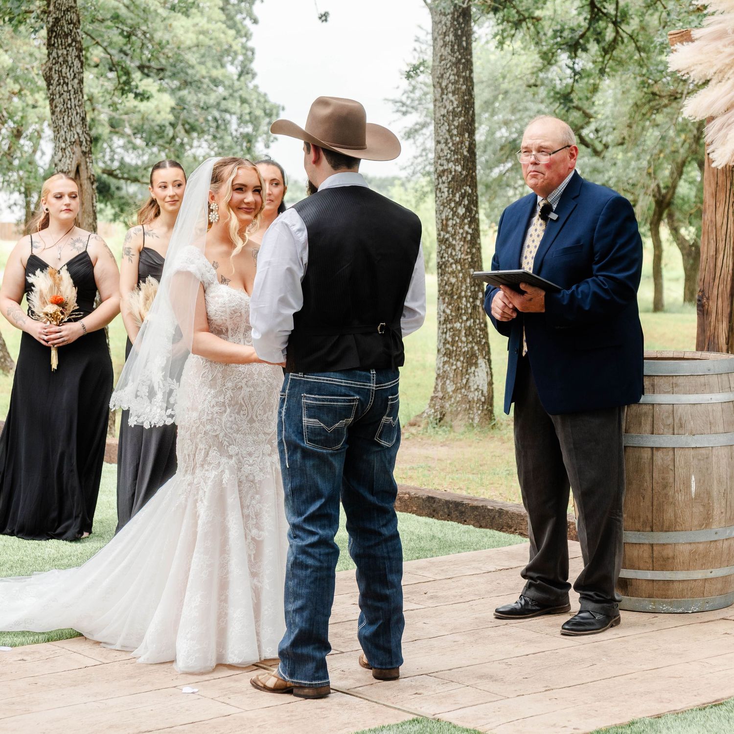 bride and groom stand at an altar with a minister
