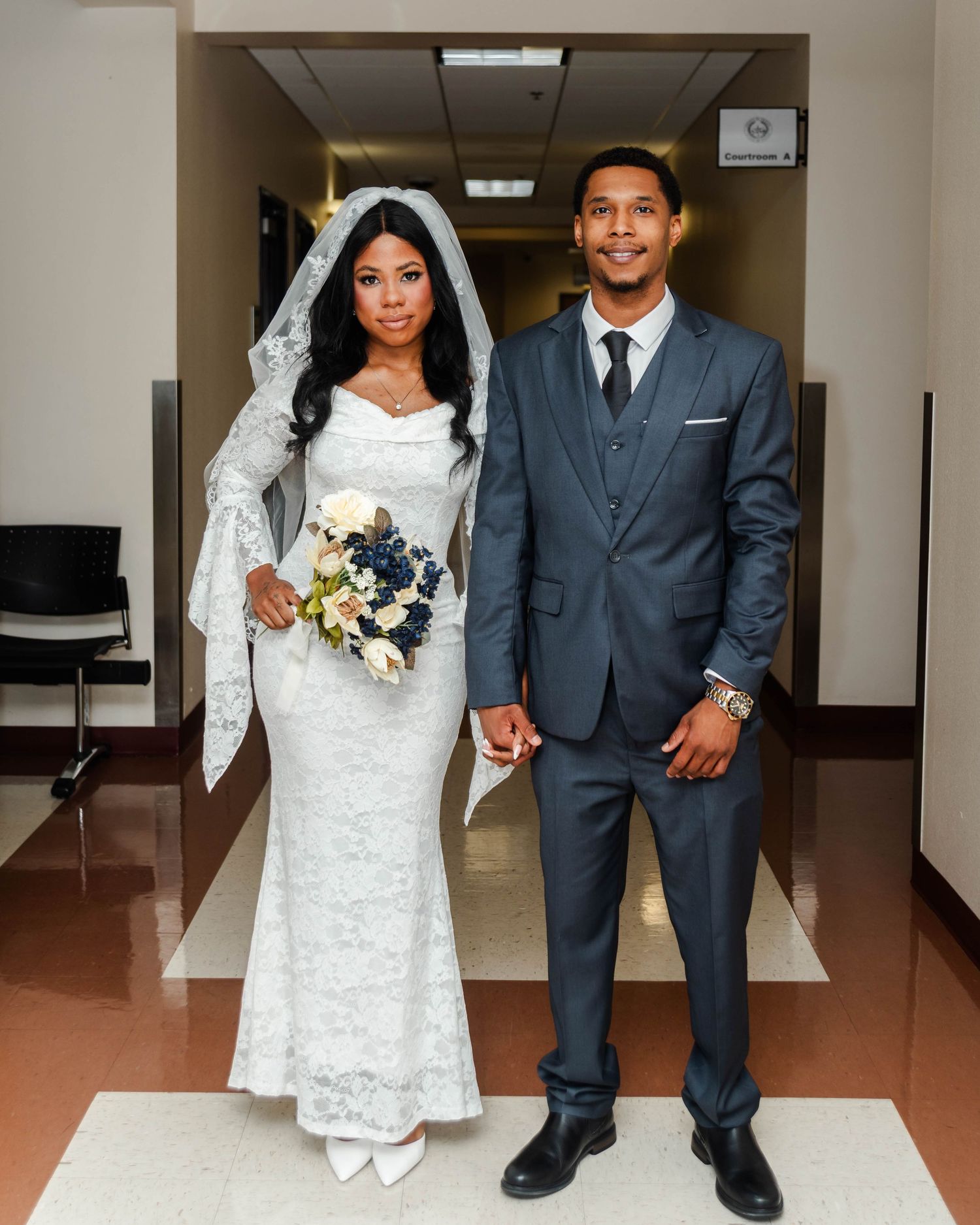 a couple stands in a courthouse to be married