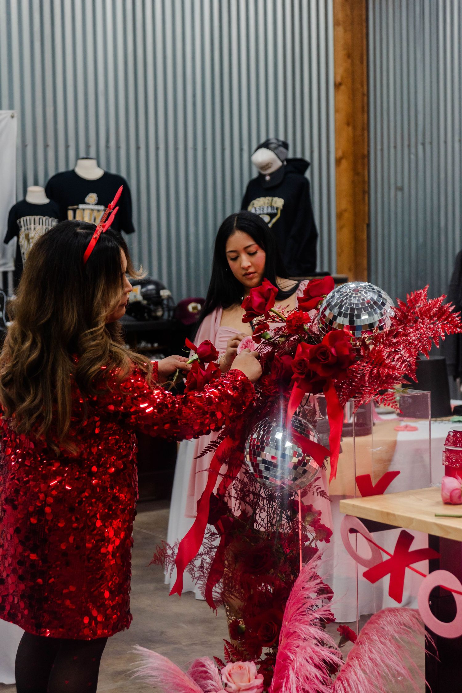 Valentine's day themed retail display with sparkly red decorations and gift merchandise.