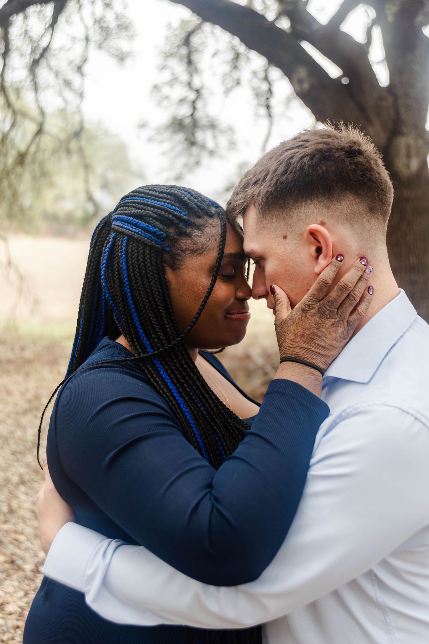 couple poses near a tree