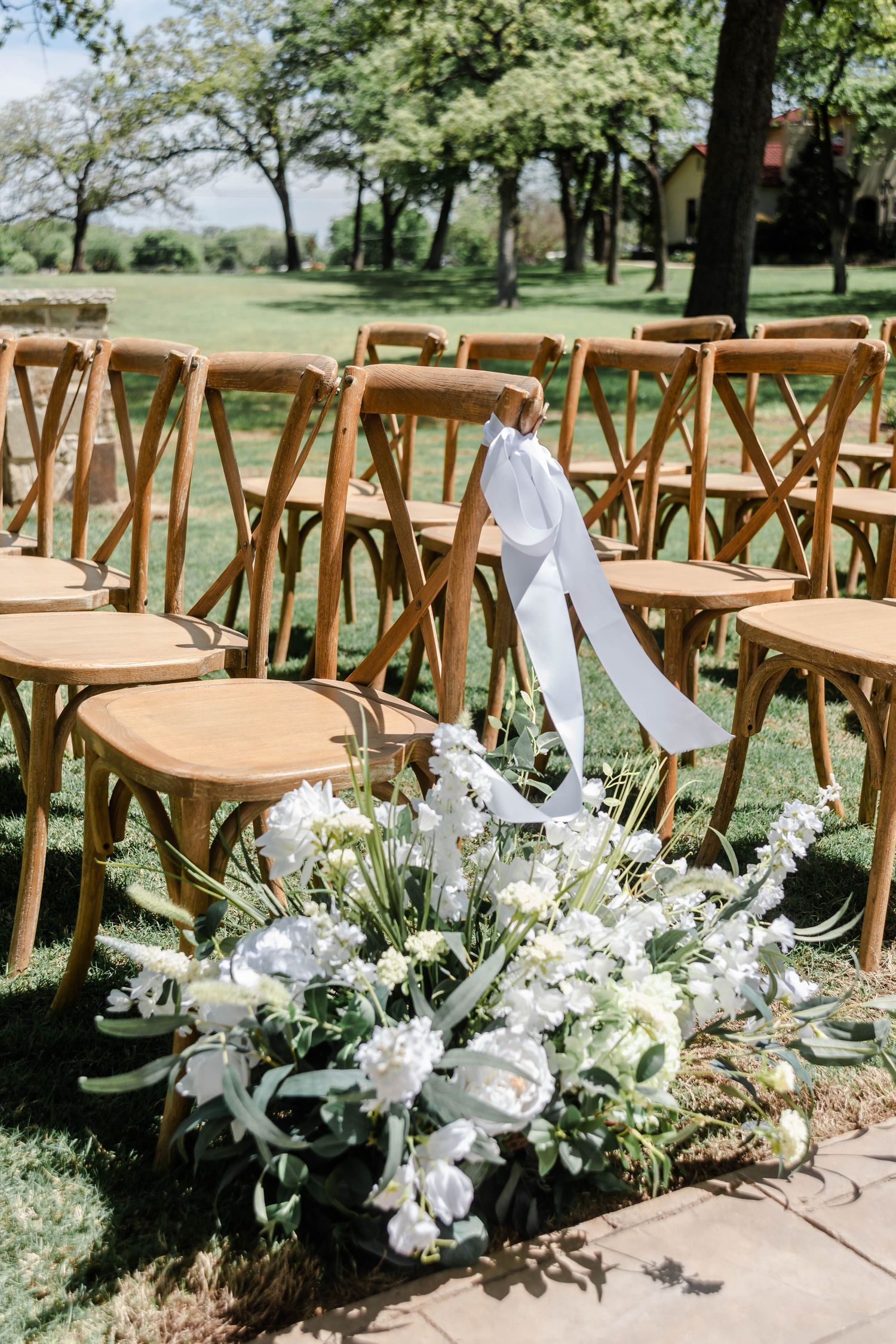 chairs with white ribbon and florals