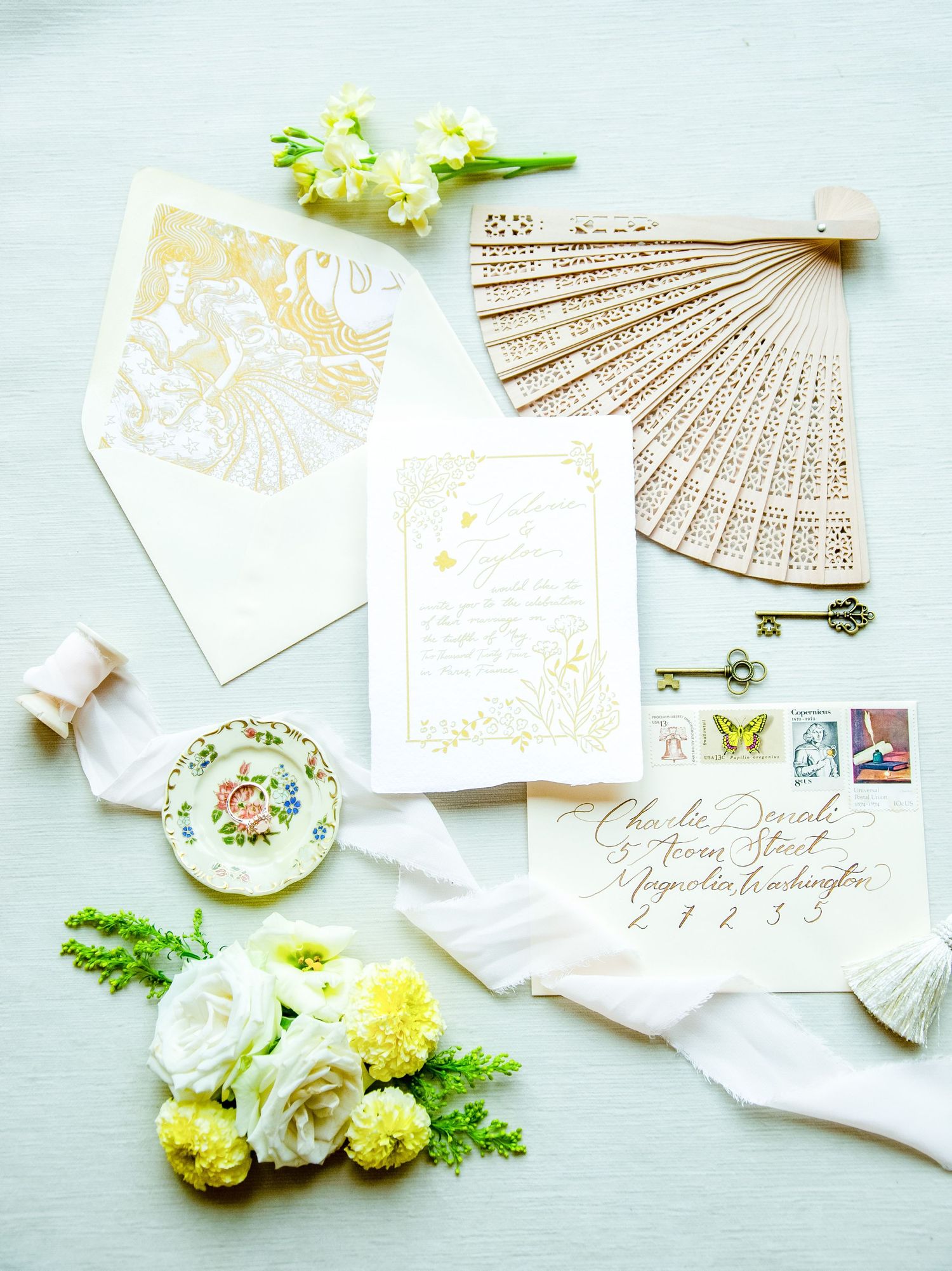 wedding invite with a fan and flowers
